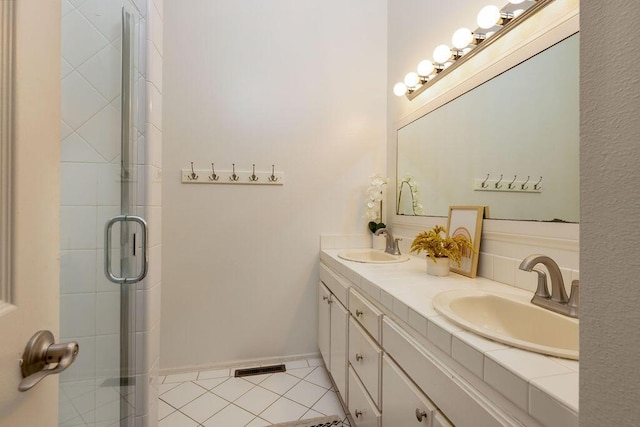 4515 Carpinteria Ave Unit G, Carpinteria, CA 93013 - full bath featuring double vanity, tile patterned flooring, and a stall shower