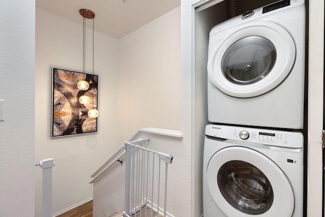 4515 Carpinteria Ave Unit G, Carpinteria, CA 93013 - laundry area with stacked washer / drying machine and wood finished floors