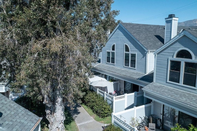 4515 Carpinteria Ave Unit G, Carpinteria, CA 93013 - view of home's exterior with a shingled roof and a chimney
