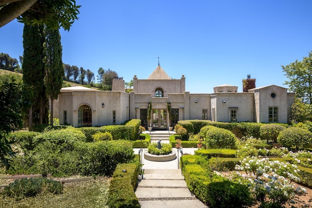 2899 Hidden Valley Ln, Montecito, CA 93108 - view of front of property with french doors, a chimney, and stucco siding