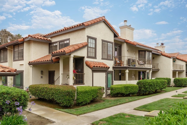 2206 Martinique Ln, Oxnard, CA 93035 - mediterranean / spanish-style home with a tile roof, a balcony, a chimney, and stucco siding