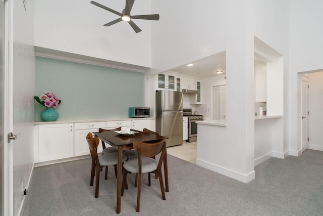 2206 Martinique Ln, Oxnard, CA 93035 - dining room featuring a high ceiling, a ceiling fan, and light carpet