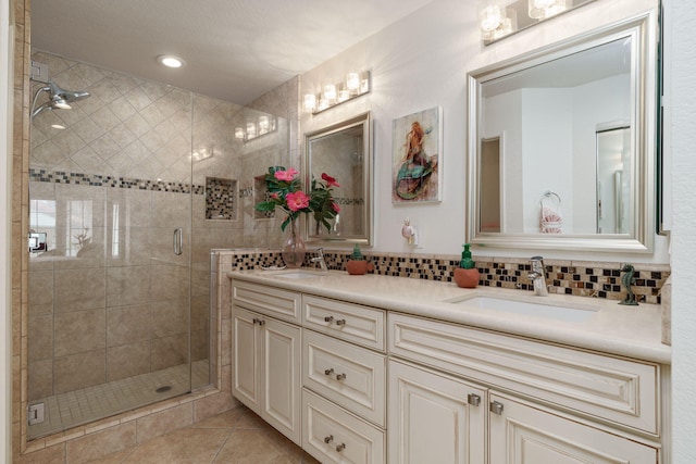 2206 Martinique Ln, Oxnard, CA 93035 - bathroom featuring double vanity, a shower stall, backsplash, tile patterned flooring, and recessed lighting