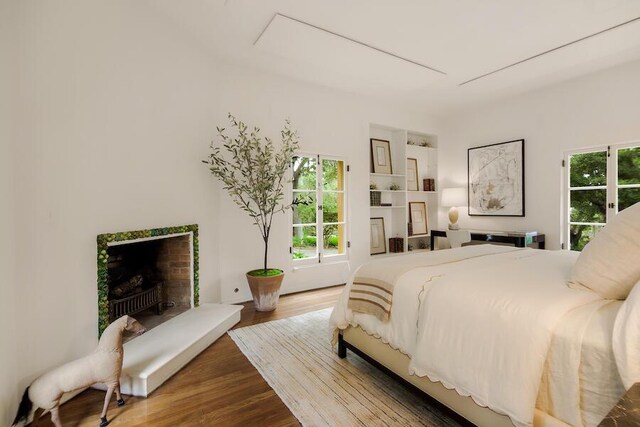405 Toro Canyon Rd, Carpinteria, CA 93013 - bedroom featuring wood finished floors and a fireplace with raised hearth