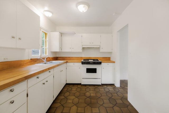405 Toro Canyon Rd, Carpinteria, CA 93013 - kitchen featuring white gas range, under cabinet range hood, white cabinets, and wooden counters