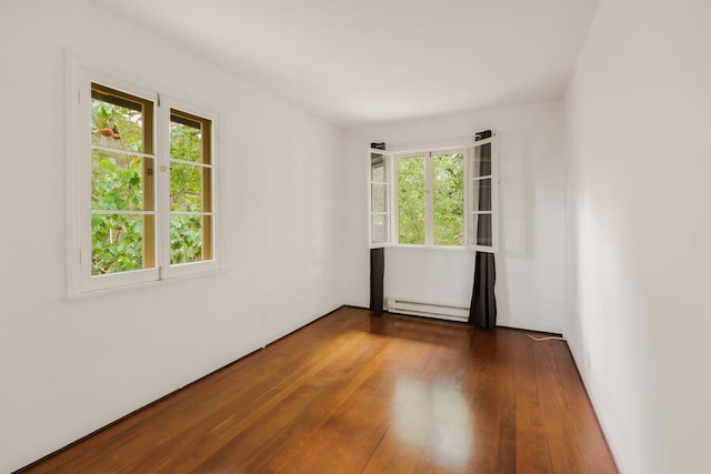 405 Toro Canyon Rd, Carpinteria, CA 93013 - empty room with a baseboard heating unit and dark wood-type flooring