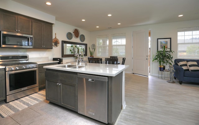 6607 Fathom Way, Goleta, CA 93117 - kitchen with stainless steel appliances, light countertops, recessed lighting, an island with sink, and dark brown cabinetry
