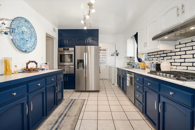 412 Milky Way, Lompoc, CA 93436 - kitchen featuring appliances with stainless steel finishes, blue cabinetry, under cabinet range hood, and white cabinets