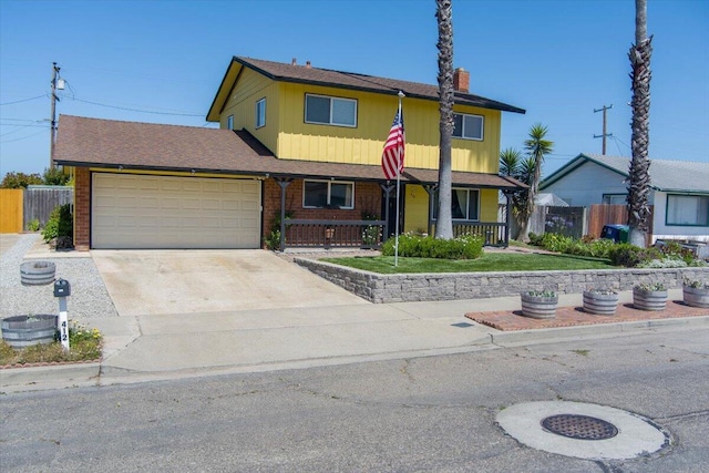 412 Milky Way, Lompoc, CA 93436 - traditional home featuring a porch, an attached garage, driveway, and a chimney