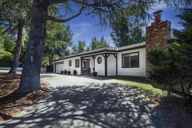 740 Alisal Rd, Solvang, CA 93463 - single story home featuring a garage, driveway, a chimney, and stucco siding