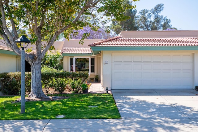 23 La Cumbre Cir, Santa Barbara, CA 93105 - view of front of home with driveway, a tile roof, an attached garage, a front yard, and stucco siding