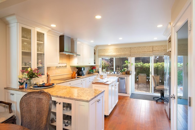 23 La Cumbre Cir, Santa Barbara, CA 93105 - kitchen with wall chimney range hood, black electric stovetop, stainless steel dishwasher, tasteful backsplash, and white cabinetry