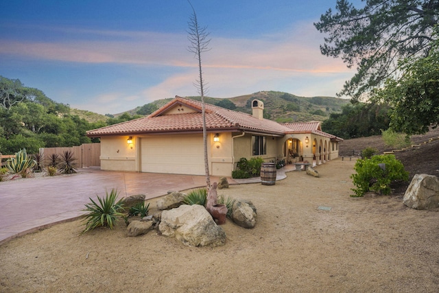 80 Bobcat Springs Rd, Buellton, CA 93427 - mediterranean / spanish-style home with a tile roof, an attached garage, a chimney, concrete driveway, and stucco siding