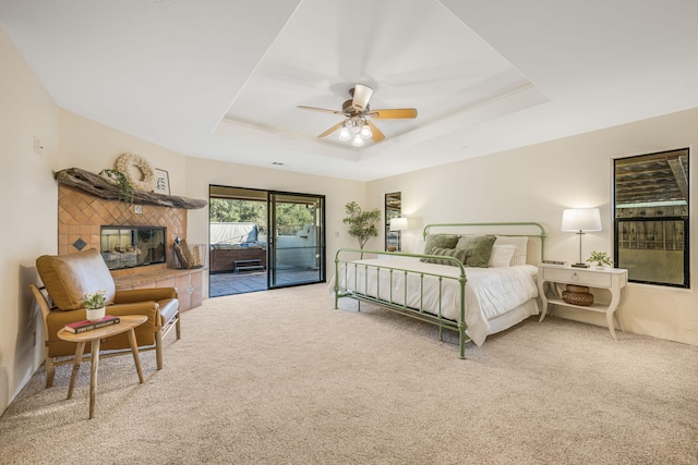 80 Bobcat Springs Rd, Buellton, CA 93427 - carpeted bedroom with access to exterior, a raised ceiling, a tiled fireplace, and ceiling fan