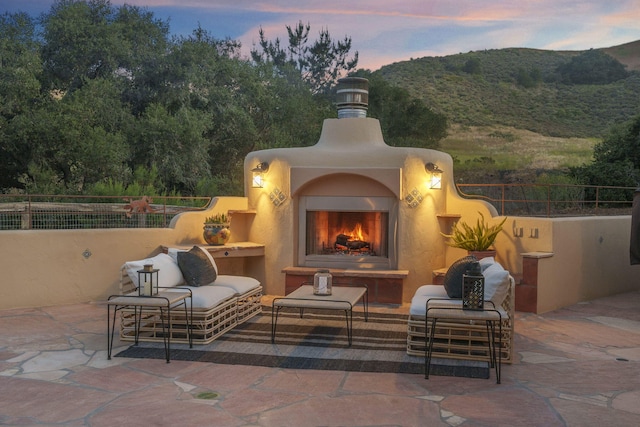 80 Bobcat Springs Rd, Buellton, CA 93427 - view of patio / terrace with a lit fireplace and a mountain view