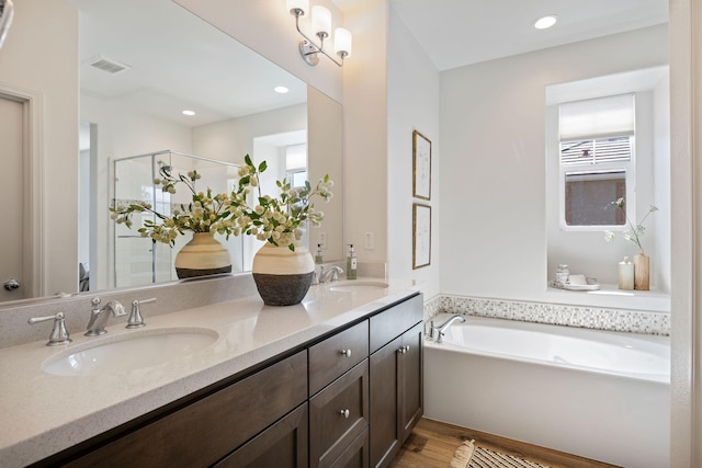 6594 Pipeline Pl, Goleta, CA 93117 - bathroom featuring a stall shower, plenty of natural light, double vanity, wood finished floors, and recessed lighting