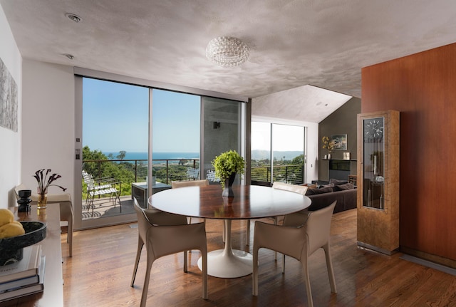 1944 Eucalyptus Hill Rd, Santa Barbara, CA 93108 - dining room with wood finished floors, floor to ceiling windows, and a chandelier
