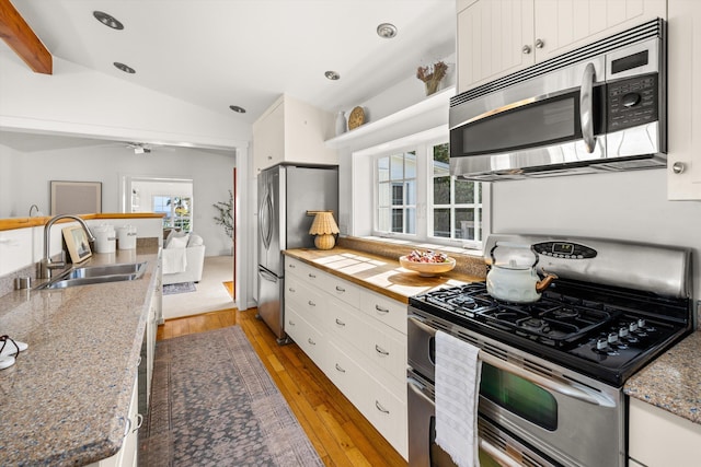 2365 Whitney Ave, Summerland, CA 93067 - kitchen with stainless steel appliances, vaulted ceiling, white cabinets, light wood-type flooring, and ceiling fan