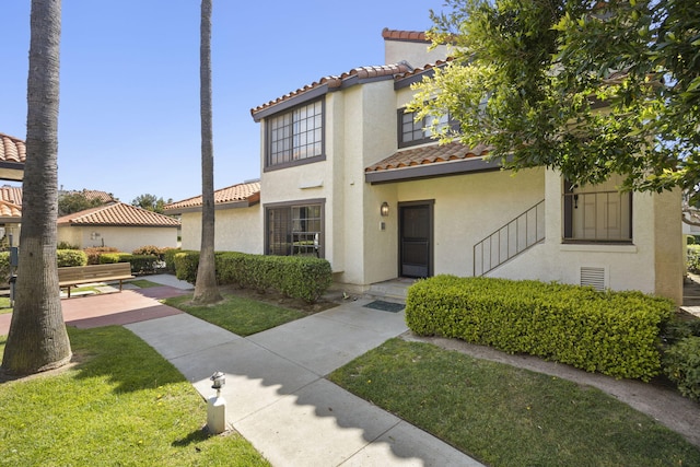 2171 Martinique Ln, Oxnard, CA 93035 - mediterranean / spanish home featuring a tiled roof, stucco siding, and a front lawn