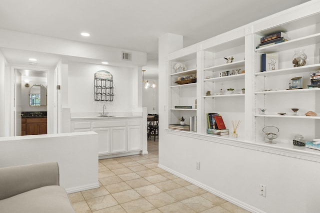 2171 Martinique Ln, Oxnard, CA 93035 - kitchen with open shelves, light tile patterned floors, white cabinets, recessed lighting, and light countertops