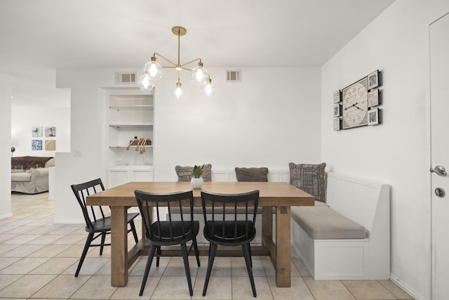 2171 Martinique Ln, Oxnard, CA 93035 - dining room with built in features, light tile patterned floors, and a chandelier