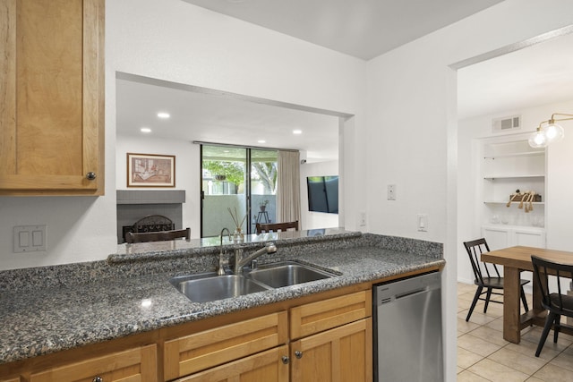 2171 Martinique Ln, Oxnard, CA 93035 - kitchen with dishwasher, light tile patterned flooring, dark stone counters, a fireplace, and recessed lighting