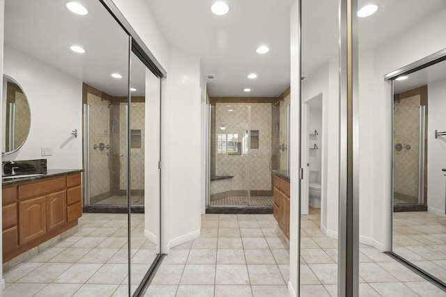 2171 Martinique Ln, Oxnard, CA 93035 - bathroom featuring tile patterned floors, vanity, a shower stall, and recessed lighting