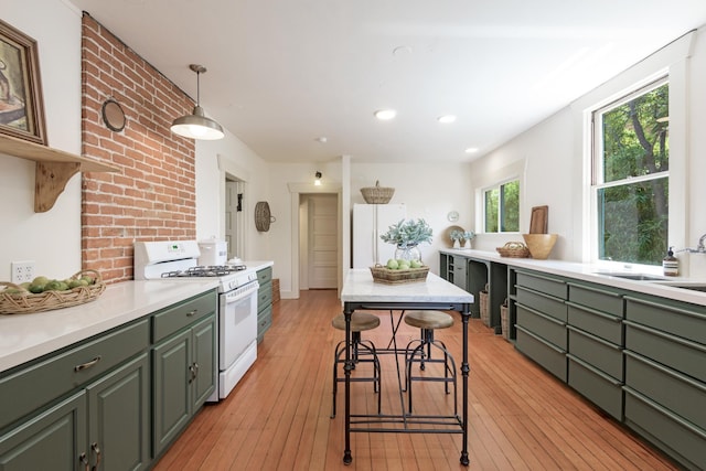 435 E Pedregosa St, Santa Barbara, CA 93101 - kitchen with white appliances, green cabinets, light countertops, light wood finished floors, and recessed lighting