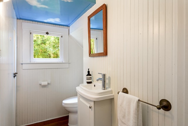 435 E Pedregosa St, Santa Barbara, CA 93101 - half bath featuring vanity, wood finished floors, and wooden walls