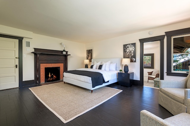 435 E Pedregosa St, Santa Barbara, CA 93101 - bedroom with dark wood-type flooring and a brick fireplace
