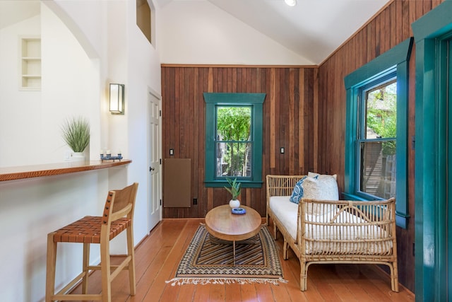 435 E Pedregosa St, Santa Barbara, CA 93101 - sitting room featuring plenty of natural light, wood walls, wood-type flooring, vaulted ceiling, and arched walkways