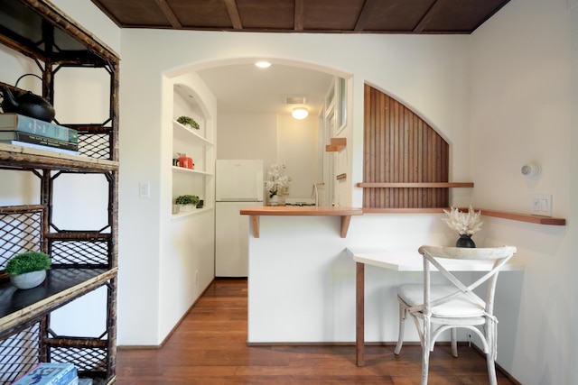 435 E Pedregosa St, Santa Barbara, CA 93101 - kitchen featuring freestanding refrigerator, arched walkways, wood finished floors, a kitchen breakfast bar, and built in features