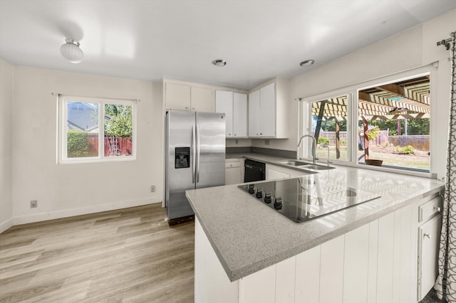 886 Raddue Ave, Santa Barbara, CA 93111 - kitchen with black appliances, a peninsula, light wood finished floors, and plenty of natural light