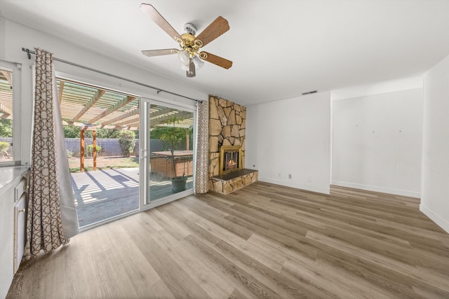 886 Raddue Ave, Santa Barbara, CA 93111 - unfurnished living room featuring wood finished floors, healthy amount of natural light, ceiling fan, and a stone fireplace