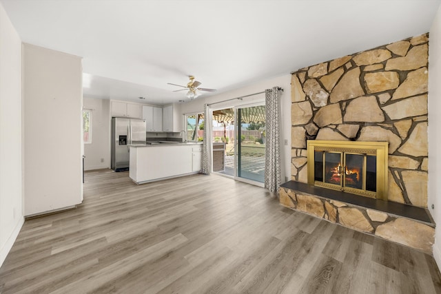 886 Raddue Ave, Santa Barbara, CA 93111 - unfurnished living room with light wood-style floors, a stone fireplace, and ceiling fan