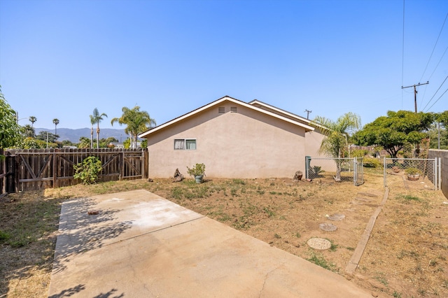 886 Raddue Ave, Santa Barbara, CA 93111 - view of home's exterior featuring stucco siding, a patio, and a fenced backyard