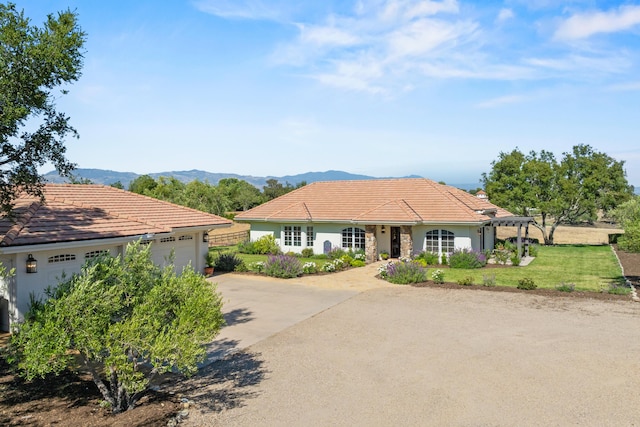 1740 Still Meadow Rd, Solvang, CA 93463 - view of front of home featuring concrete driveway, a garage, a tile roof, a mountain view, and a front yard