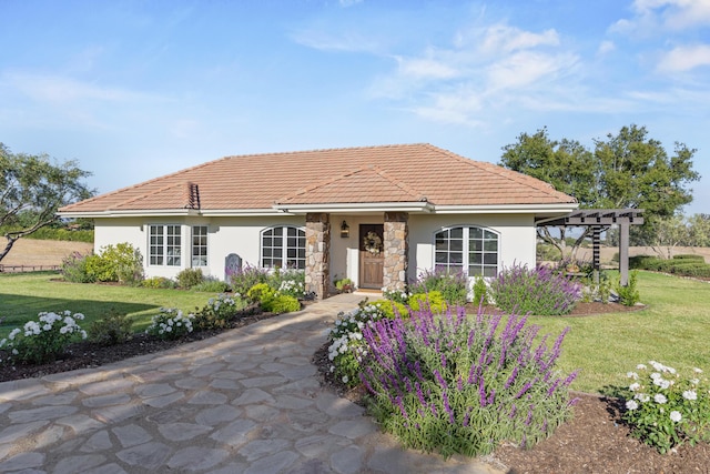 1740 Still Meadow Rd, Solvang, CA 93463 - view of front of home with a front yard, stucco siding, a pergola, stone siding, and a tiled roof