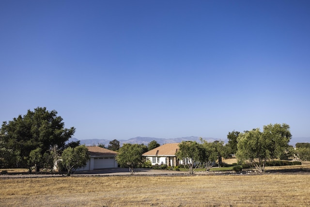 1740 Still Meadow Rd, Solvang, CA 93463 - view of front facade with a mountain view, a garage, and driveway