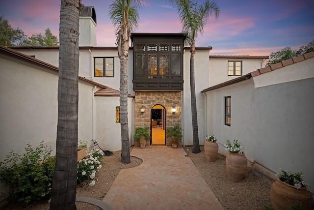 2641 Dorking Pl, Santa Barbara, CA 93105 - entrance to property with stucco siding, stone siding, a chimney, and a patio