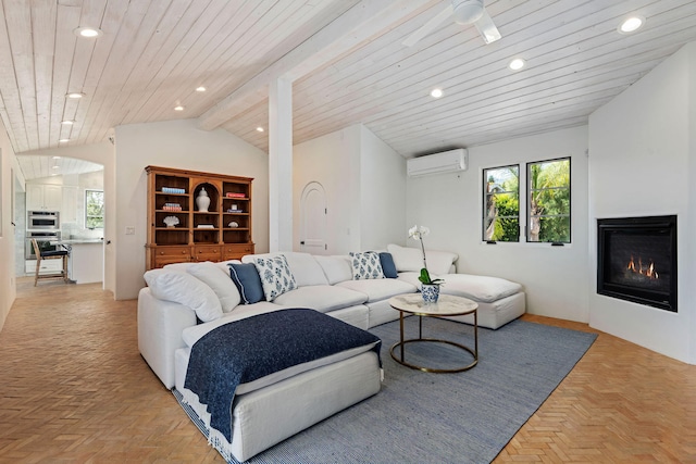 2641 Dorking Pl, Santa Barbara, CA 93105 - living room featuring a wall unit AC, vaulted ceiling, recessed lighting, a glass covered fireplace, and plenty of natural light
