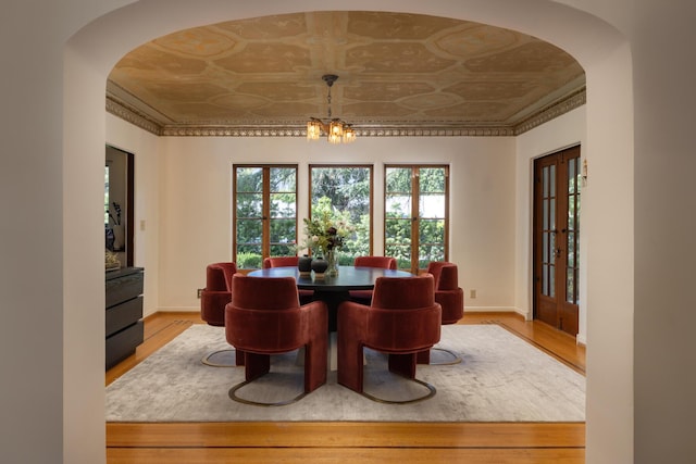 205 S Lomita Ave, Ojai, CA 93023 - dining area with arched walkways, light wood finished floors, an ornate ceiling, and a chandelier