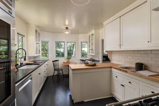 205 S Lomita Ave, Ojai, CA 93023 - kitchen with butcher block countertops, dishwasher, white cabinets, and glass insert cabinets