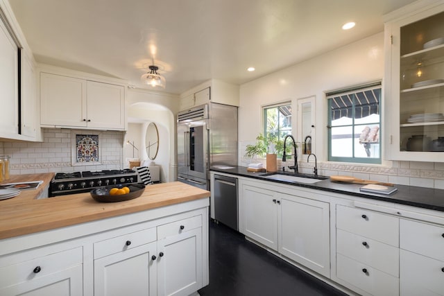 205 S Lomita Ave, Ojai, CA 93023 - kitchen featuring butcher block counters, appliances with stainless steel finishes, tasteful backsplash, glass insert cabinets, and recessed lighting