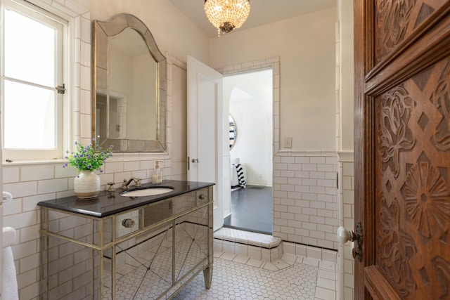205 S Lomita Ave, Ojai, CA 93023 - bathroom with vanity, tile patterned floors, tile walls, healthy amount of natural light, and a chandelier