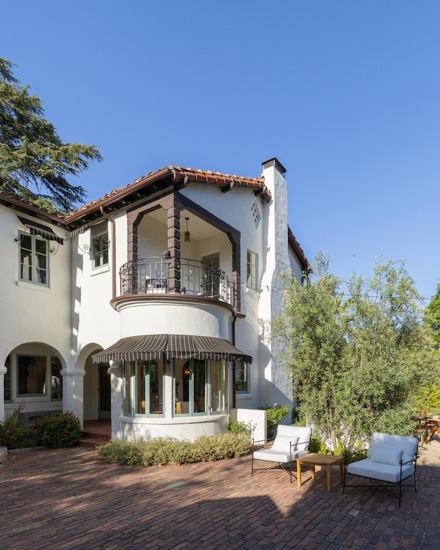 205 S Lomita Ave, Ojai, CA 93023 - rear view of property featuring a balcony, a chimney, a patio, stucco siding, and a tiled roof