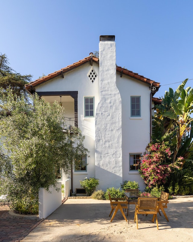 205 S Lomita Ave, Ojai, CA 93023 - view of side of home with a chimney, stucco siding, and a patio area