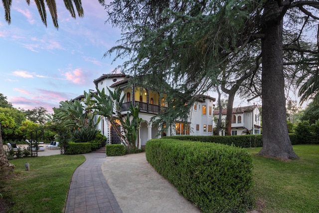 205 S Lomita Ave, Ojai, CA 93023 - view of front of home with a balcony, stucco siding, a front yard, and a tiled roof