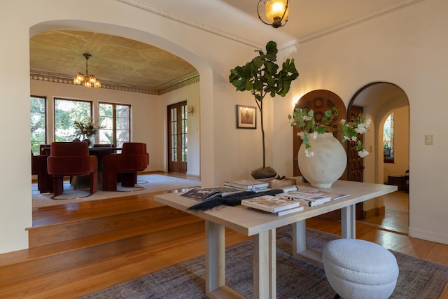 205 S Lomita Ave, Ojai, CA 93023 - dining space featuring arched walkways, wood finished floors, a chandelier, and ornamental molding