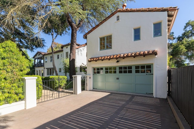 205 S Lomita Ave, Ojai, CA 93023 - mediterranean / spanish house featuring stucco siding, an attached garage, and a tiled roof